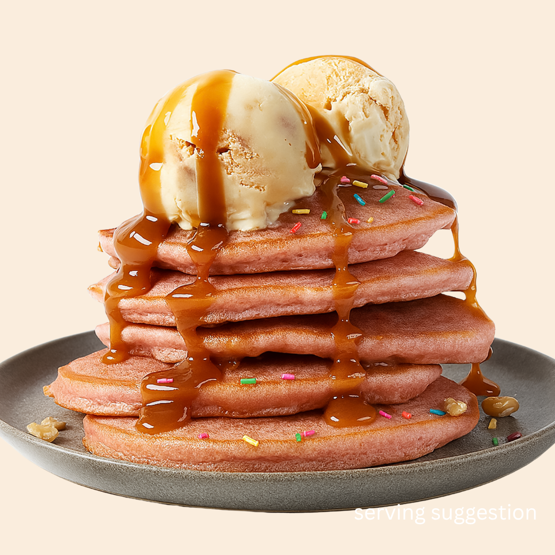 Stack of pink unicorn flavoured SwoleCakes protein pancakes with ice cream and caramel sauce as a serving suggestion for NZ and AUS purchasers or the product online from the SwoleCakes website.