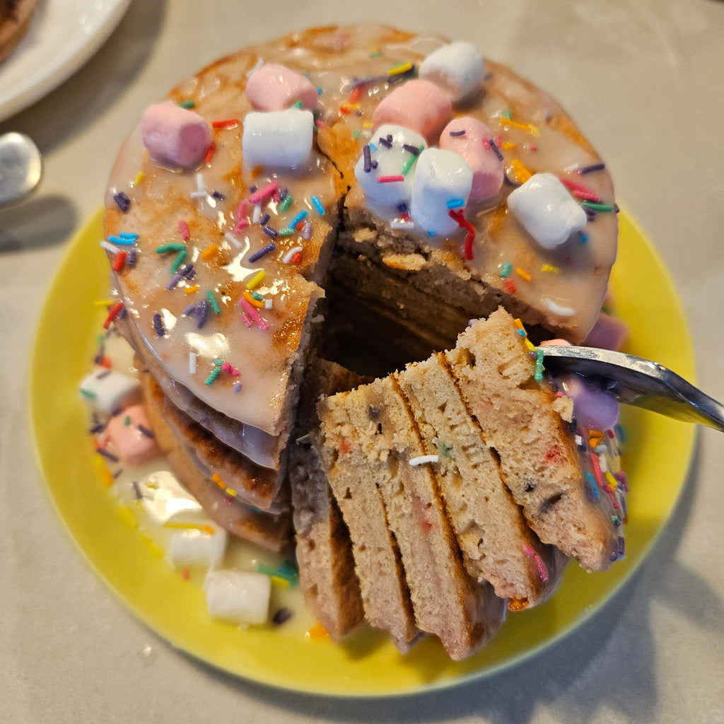 Stack of SwoleCakes protein pancakes with colorful toppings as a serving suggestion for those that order the product on the SwoleCakes website store as New Zealand or Australia customers. 